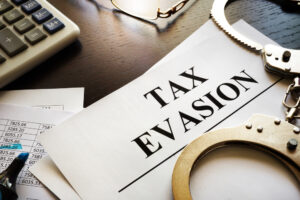 image of a tax evasion file with handcuffs