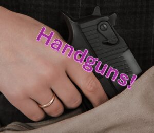 woman putting her hand gun in her purse