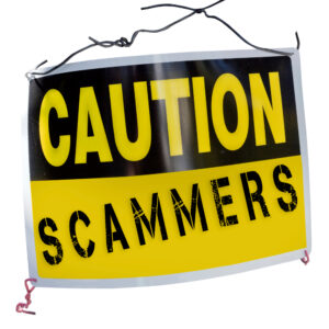 caution sign that says scammers