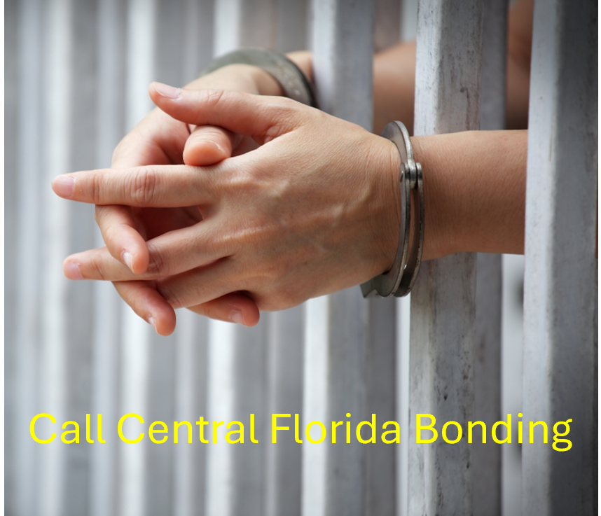 handcuffs on a set of hands and hands in jail cell